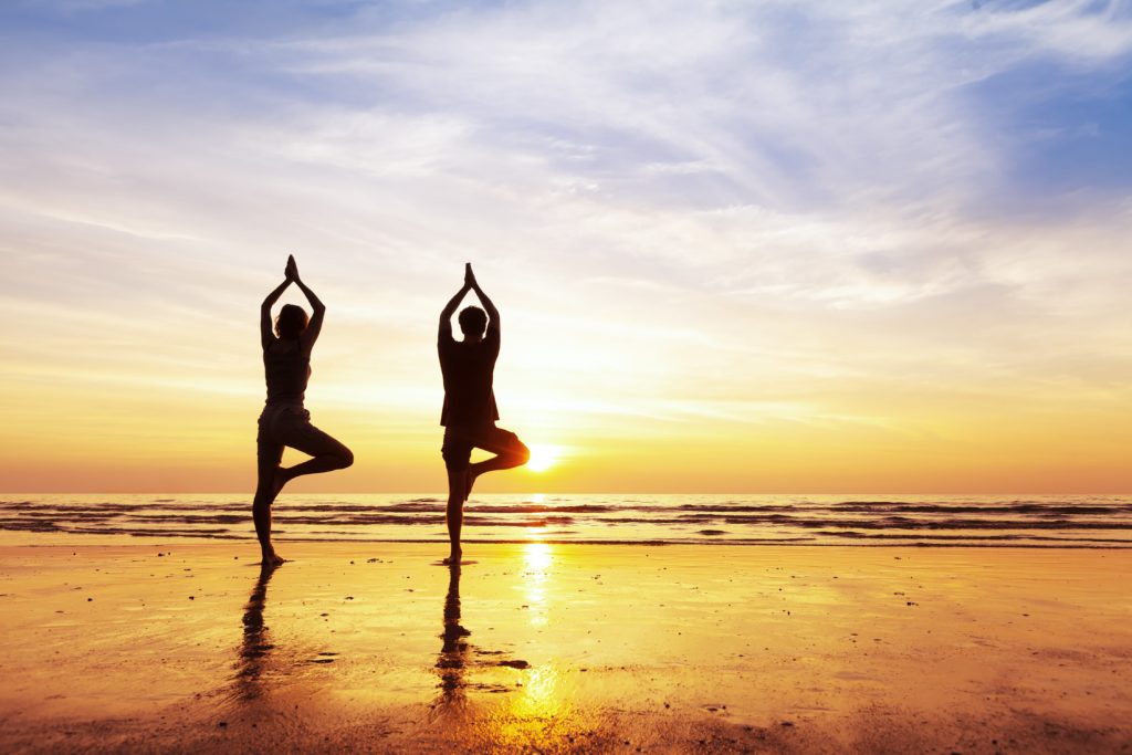 yoga on the beach at holistic drug rehab