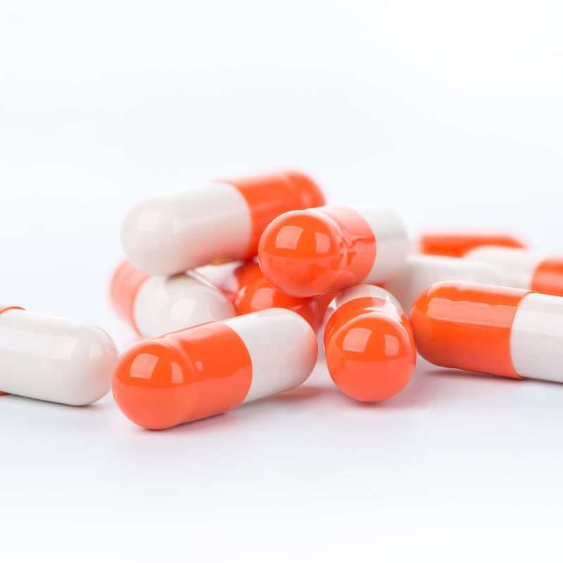 white and orange Adderall capsules