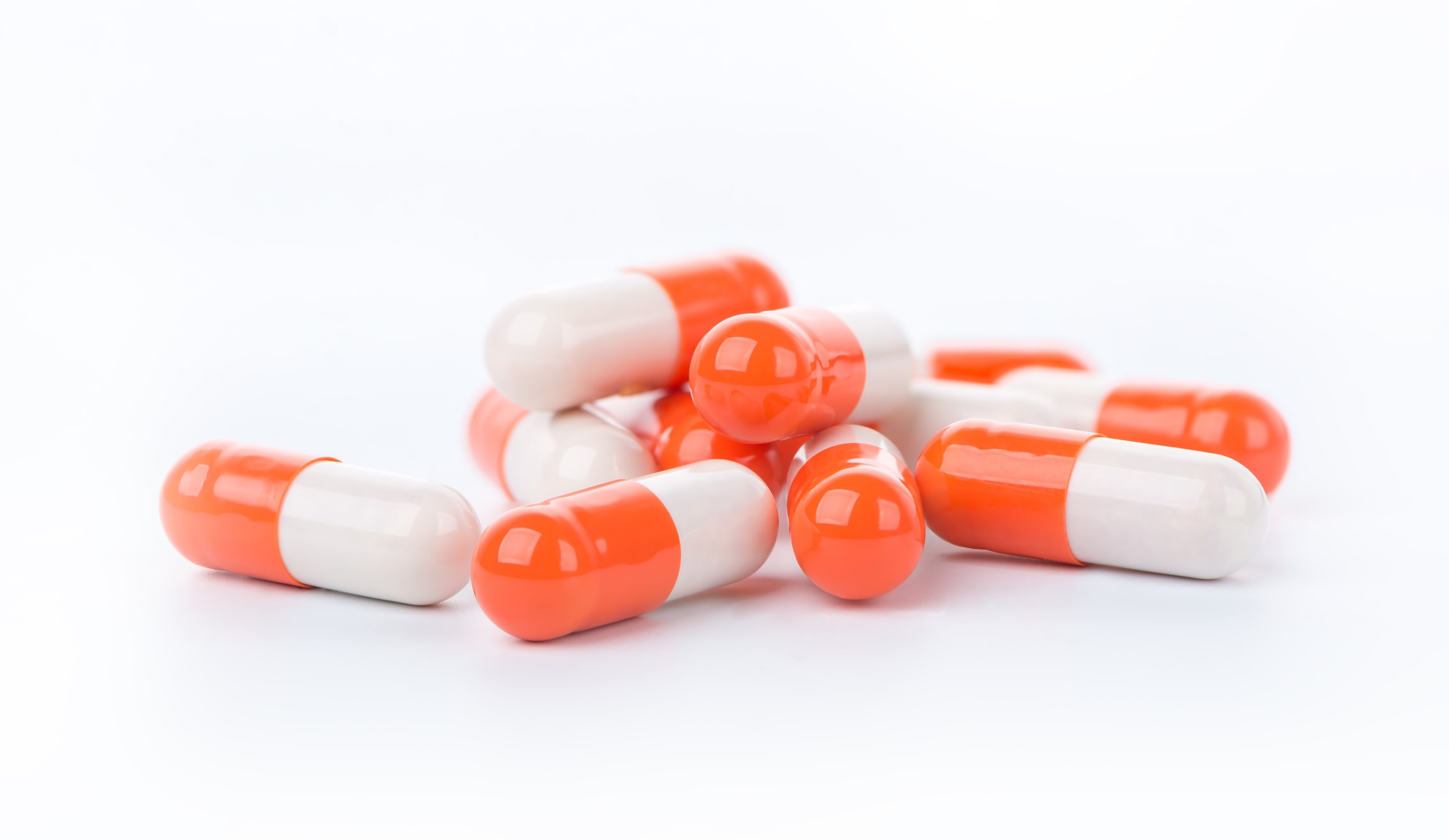 white and orange Adderall capsules