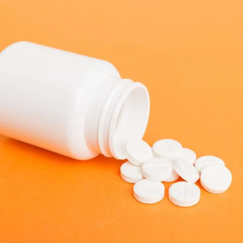 white Seroquel tablets on an orange background