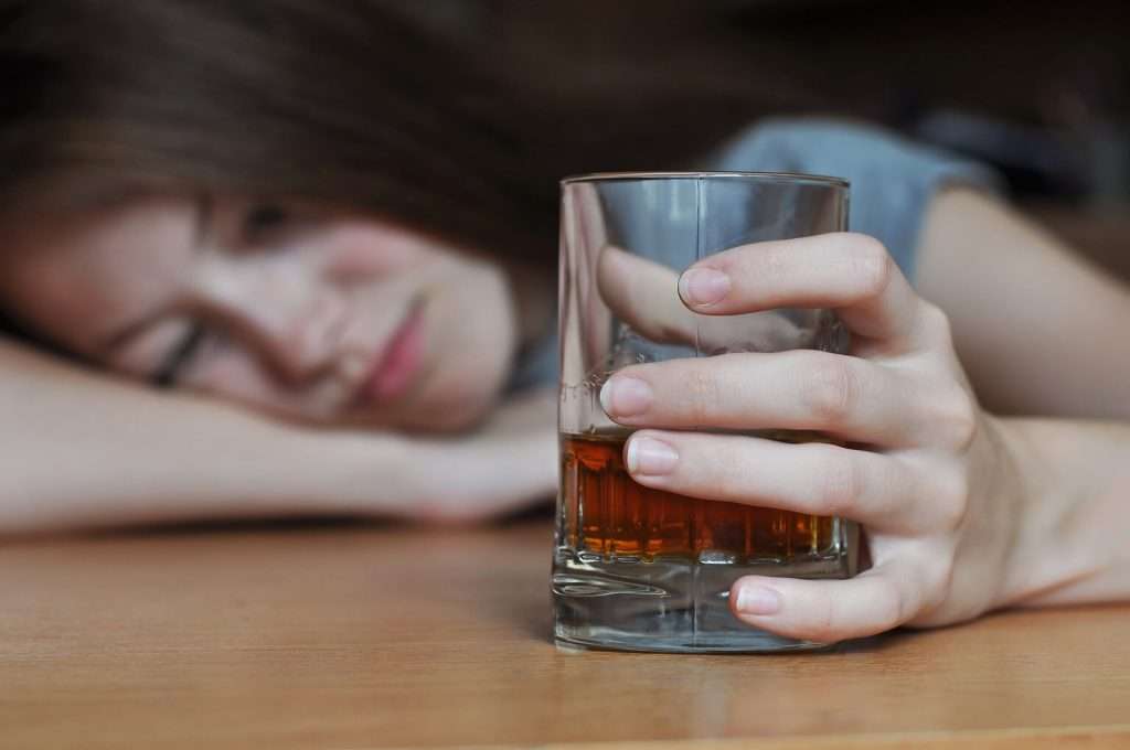 woman feeling drowsy from the side effects of Wellbutrin and alcohol