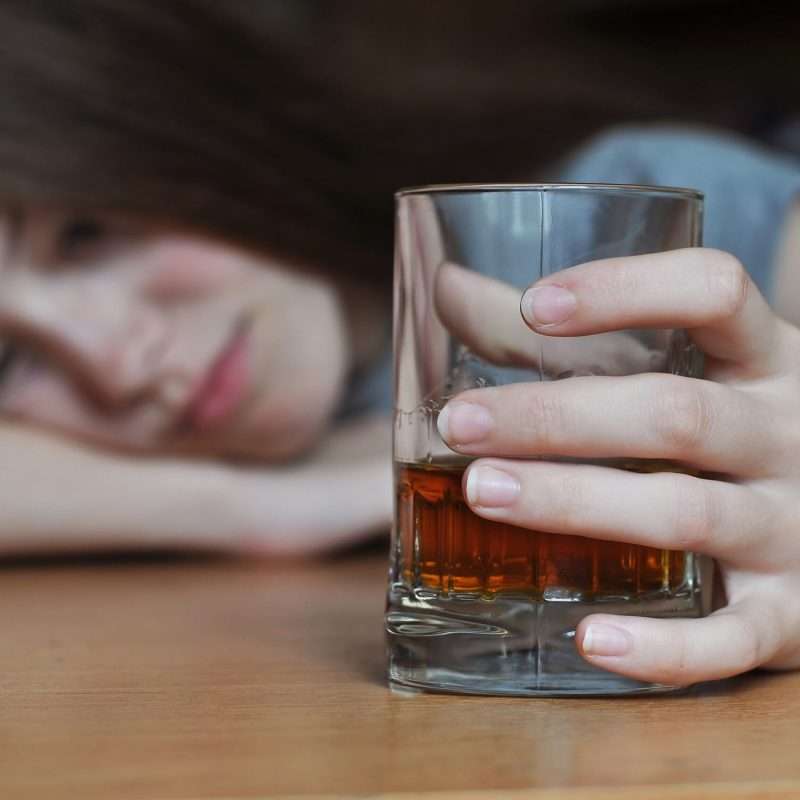 woman feeling drowsy from the side effects of Wellbutrin and alcohol