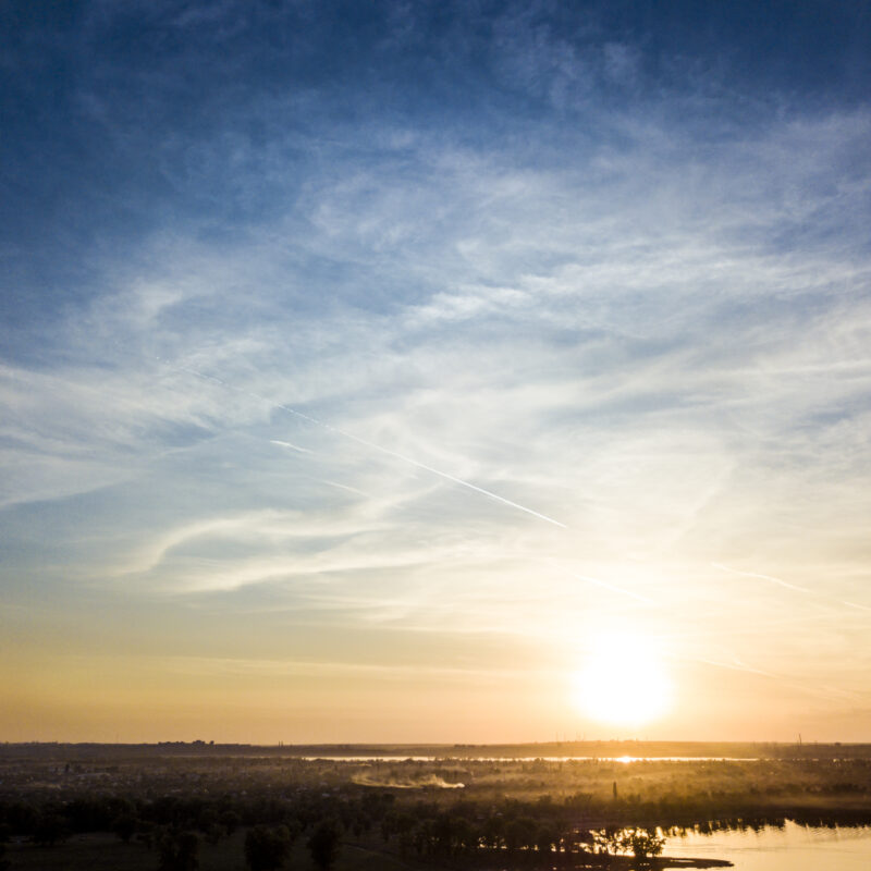 A sunrise over a river - a representation of the beauty of addiction counseling