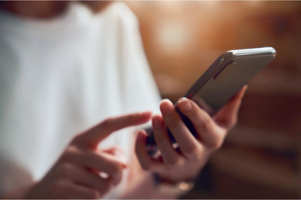 person using cell phone to text family during rehab in Tampa
